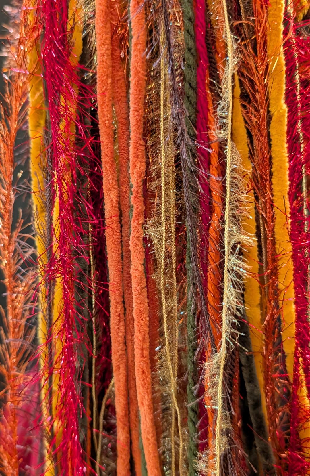Close up of Gold-Burnt Orange-Burgundy-Sage Green-Brown Slouchy Beanie Hat with Sparkle, Texture & Fur and Long Tail Fringe.