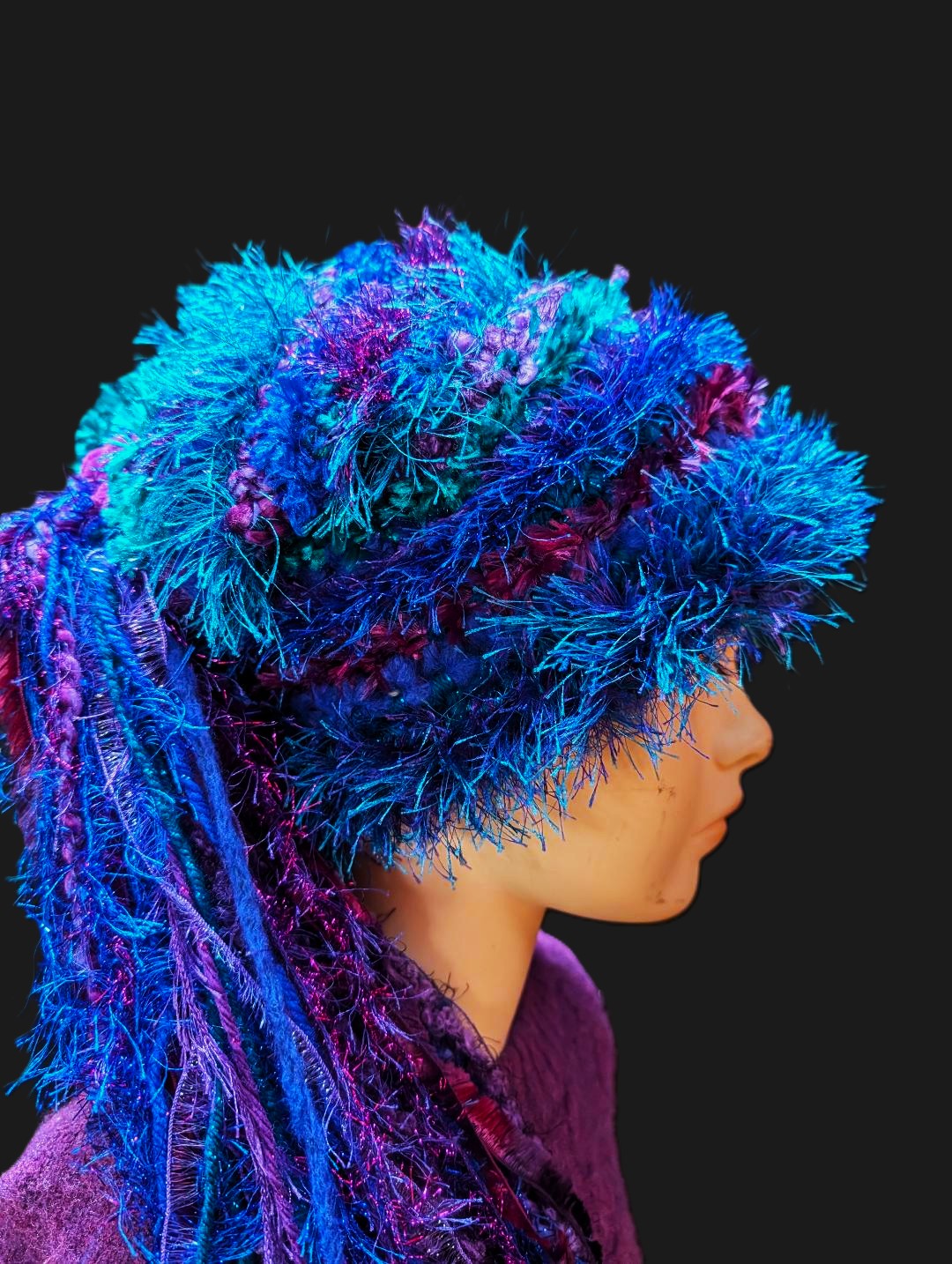 Crocheted Bright Slouchy Beanie in Blue-Purple-Teal with Sparkle, Texture, Fur & Long Tail Fringe. Close-up View of Hat Crown.