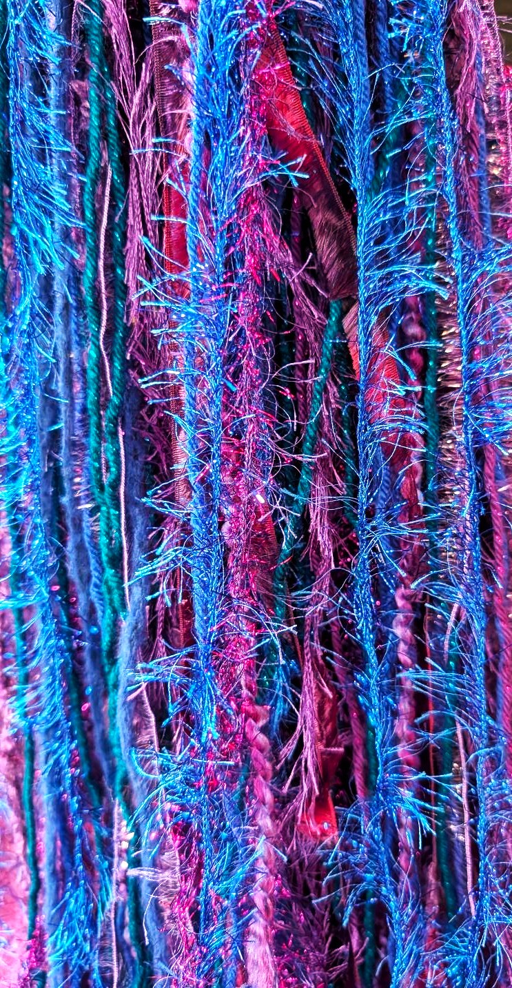 Crocheted Bright Blue-Purple-Teal Slouchy Beanie Hat with Sparkle, Texture, Fur & Long Tail Fringe. Close-up of Long Fringed Tail.