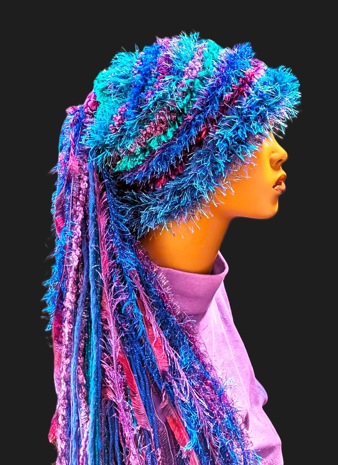Crocheted Bright Slouchy Beanie Hat in Blue-Purple-Teal with Sparkle, Texture, Fur & Long Tail Fringe. Side View.