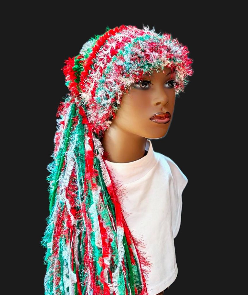 Bright Red, White, Green Christmas Hat with Sparkle, Texture, Fur & Long Tail Fringe. Corner View showing Head & Torso with Full Length Hat with Fringed Tail.