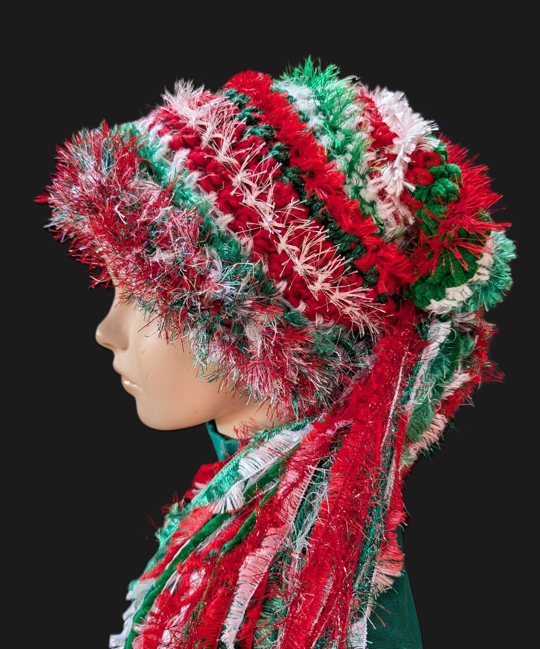 Bright Red, White, Green Christmas Hat with Sparkle, Texture, Fur & Long Tail Fringe. Side View.