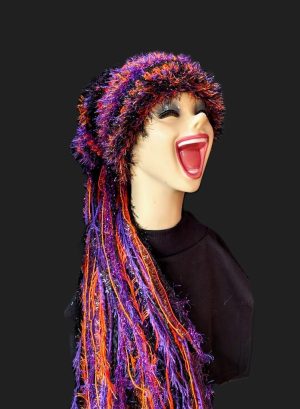 Black, Purple & Orange Halloween Slouchy Beanie Hat with Sparkle, Texture, Fur & Long Tail Fringe. Corner View of Head & Torso with Full Hat Length.