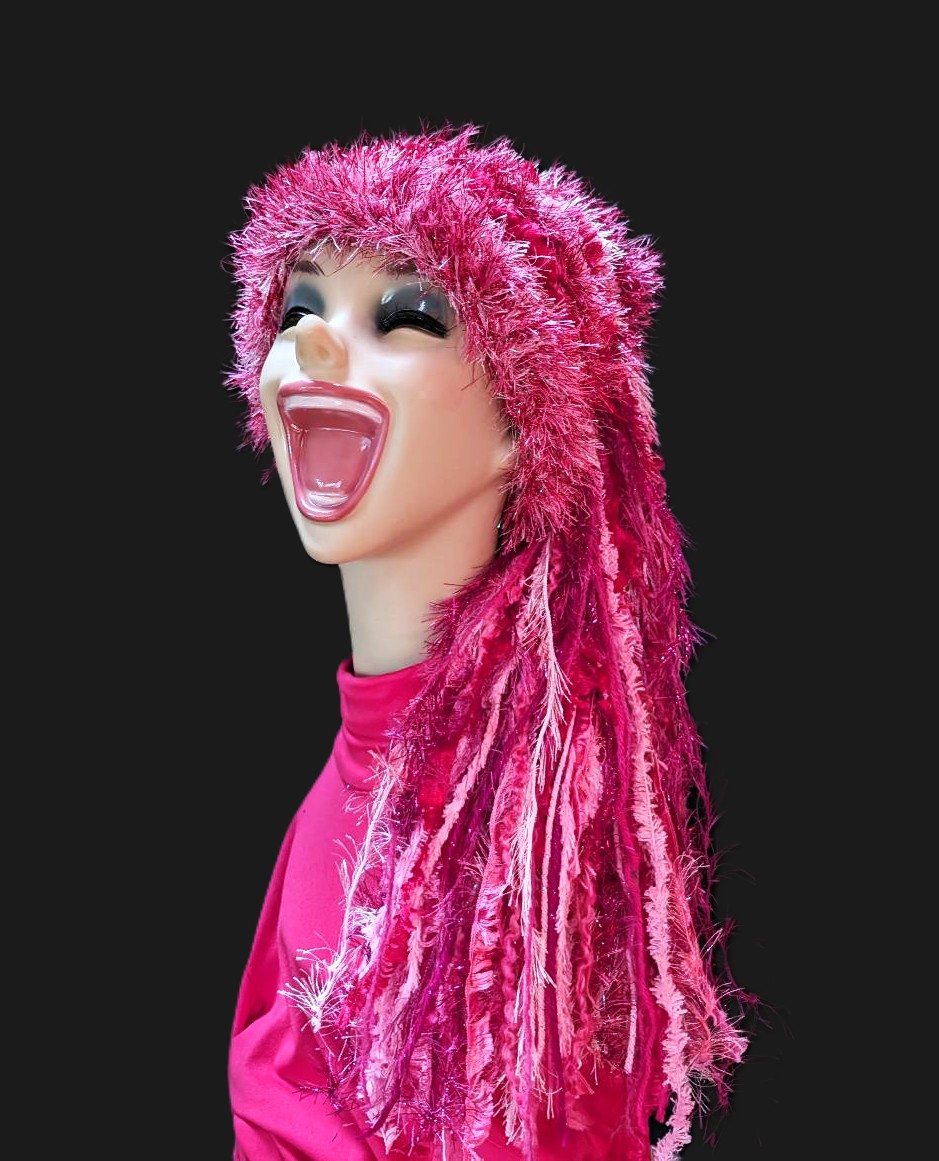 Bright Crocheted Slouchy Beanie Hat in Shades of Pink with Sparkle, Texture, Fur & Long Tail Fringe. Front-Side View Showing Entire Hat.