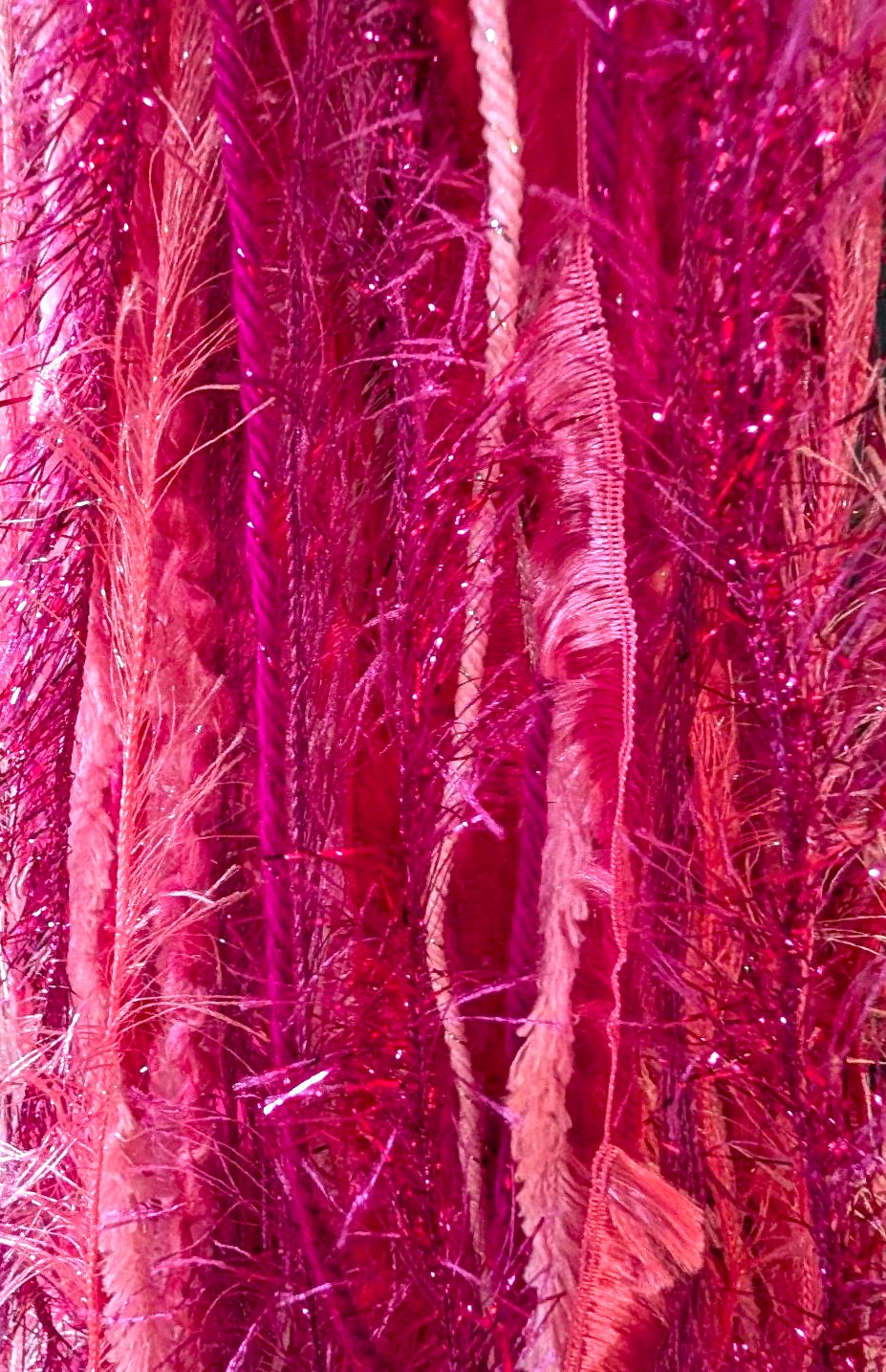 Bright Crocheted Slouchy Beanie Hat in Shades of Pink with Sparkle, Texture, Fur & Long Tail Fringe. Close-Up View of Long Fringed Tail.