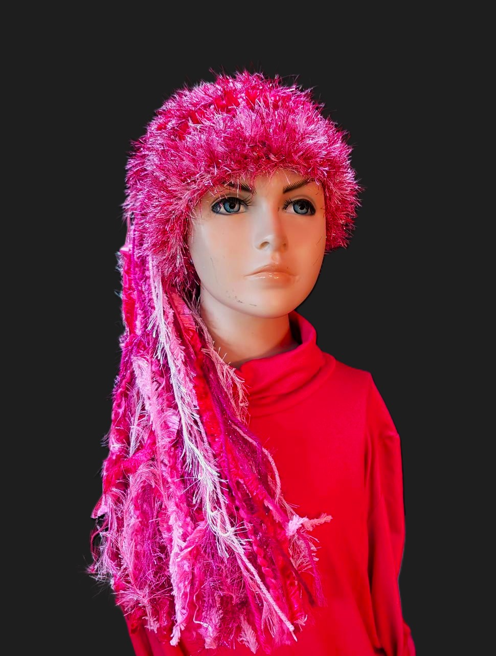 Crocheted Slouchy Beanie Hat in Bright Shades of Pink with Sparkle, Texture, Fur & Long Tail Fringe. View of Head & Torse with Full Length of Hat.