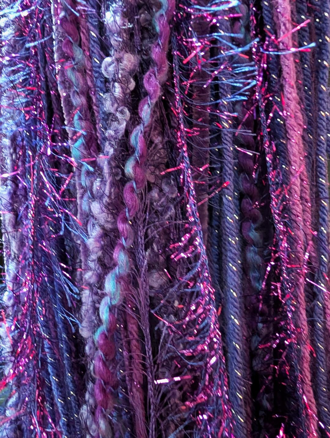 Purple Crocheted Slouchy Beanie Hat with Sparkle, Texture, Fur & Long Tail Fringe. Close-up View of Long Fringed Tail.